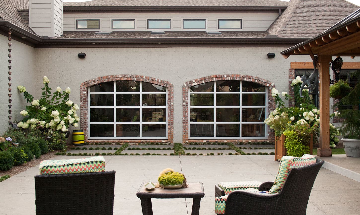 Ventana full-view glass garage doors opening a patio to the outdoors