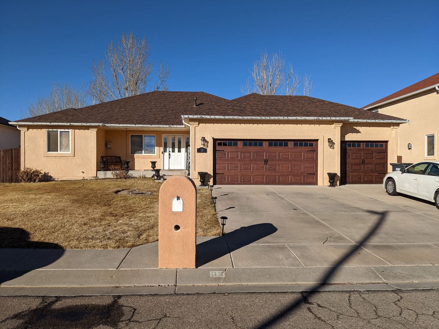 Brown wood-grain garage door installed on a Pueblo, Colorado home